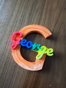 Rainbow painted name sign made by a child