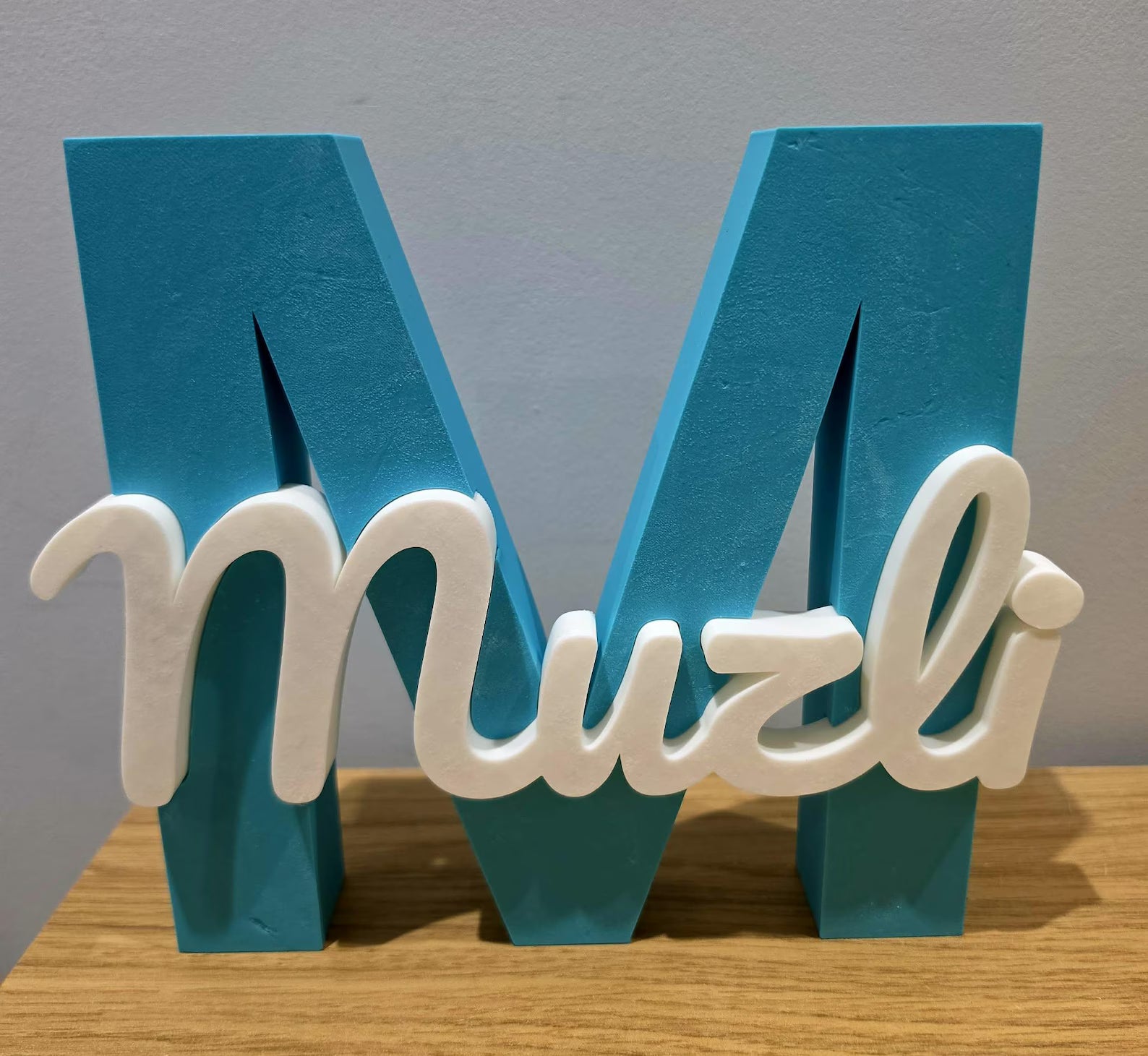 Teal and white painted name sign